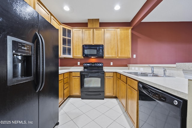 kitchen with light tile patterned flooring, sink, and black appliances