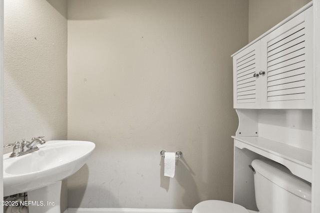 bathroom featuring sink and toilet