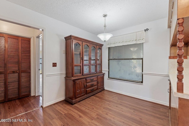 dining space with dark hardwood / wood-style flooring and a textured ceiling