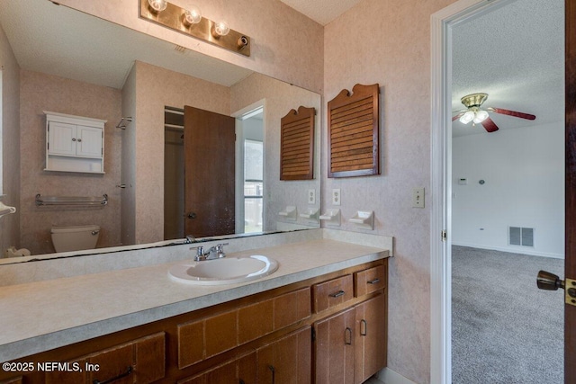 bathroom with vanity, ceiling fan, and toilet