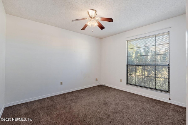 unfurnished room featuring ceiling fan, dark carpet, and a textured ceiling