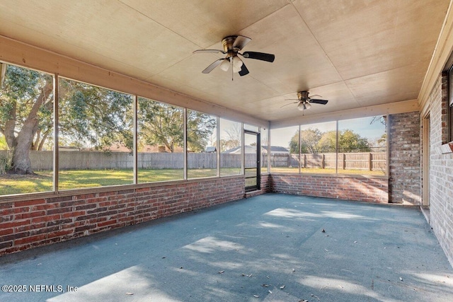 unfurnished sunroom featuring ceiling fan