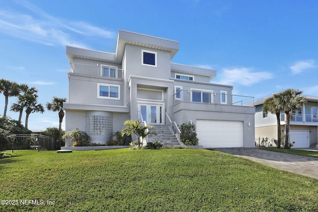 view of front of home featuring a garage and a front lawn