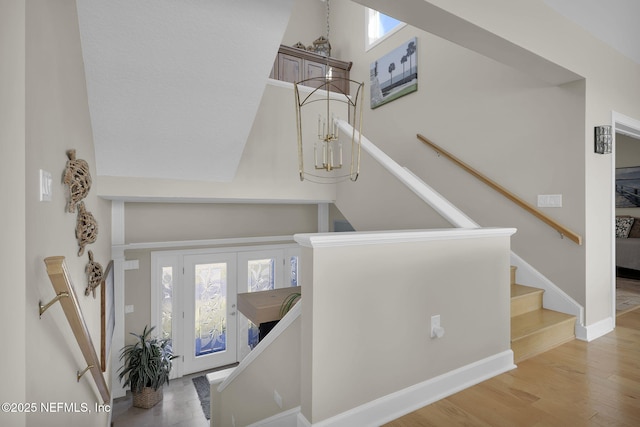 stairway featuring wood-type flooring and a wealth of natural light