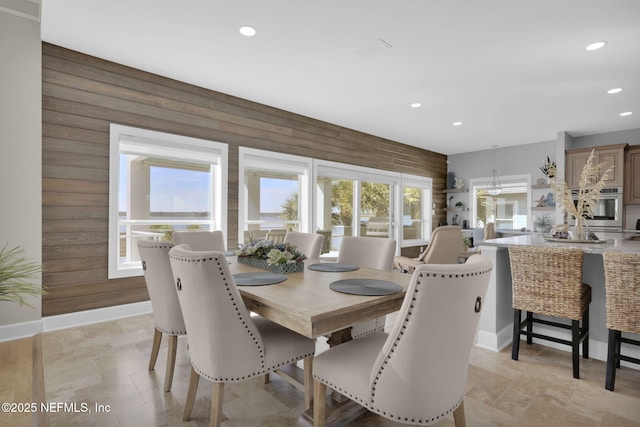 dining room with wood walls