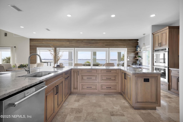 kitchen featuring pendant lighting, sink, plenty of natural light, and stainless steel appliances