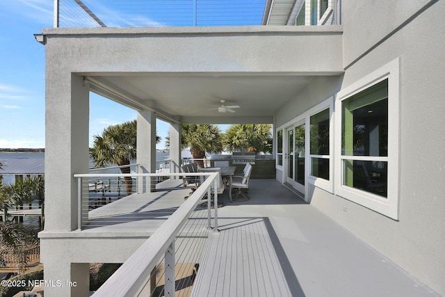 wooden terrace with a patio and ceiling fan