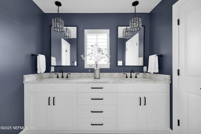 bathroom featuring vanity and a chandelier