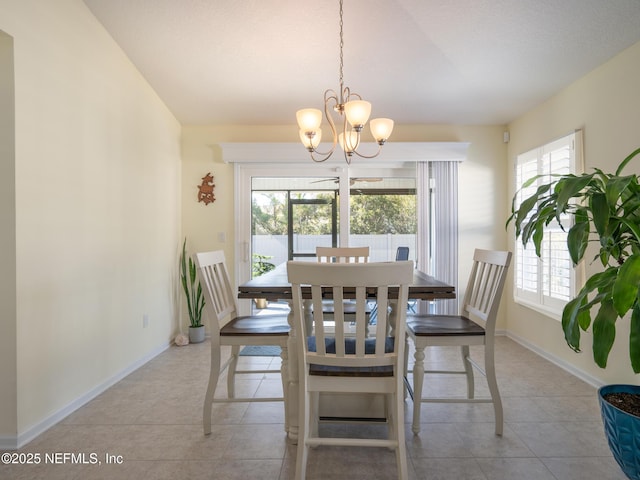 dining space with light tile patterned floors and a notable chandelier