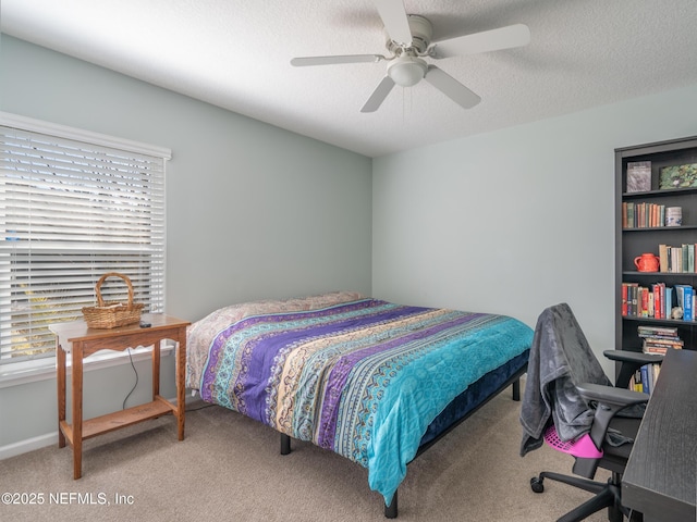 carpeted bedroom with ceiling fan, multiple windows, and a textured ceiling