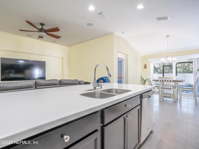 kitchen with sink, vaulted ceiling, hanging light fixtures, stainless steel dishwasher, and ceiling fan with notable chandelier