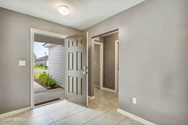 foyer entrance with light tile patterned flooring