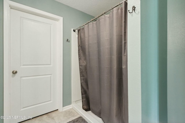 bathroom with tile patterned flooring and a shower with shower curtain