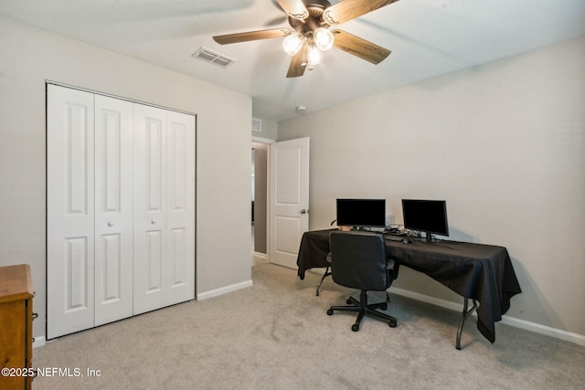 home office featuring ceiling fan and light carpet