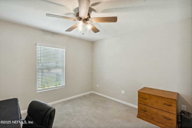 living area with light carpet and ceiling fan