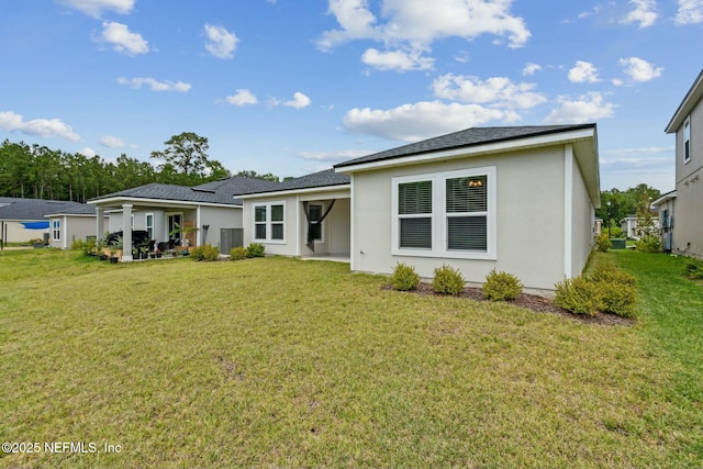 rear view of property with a patio area and a lawn