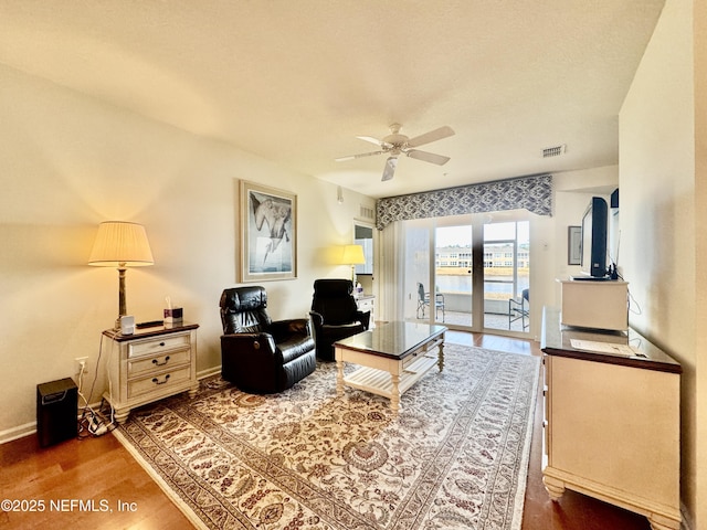 living room featuring hardwood / wood-style floors and ceiling fan