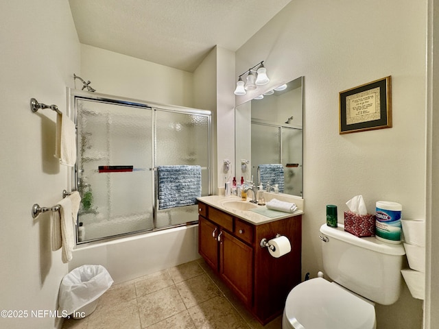 full bathroom featuring bath / shower combo with glass door, vanity, a textured ceiling, tile patterned floors, and toilet