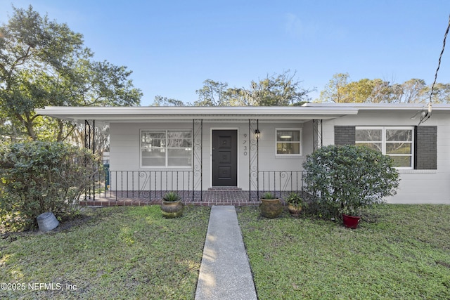 view of front of house featuring a front yard and covered porch