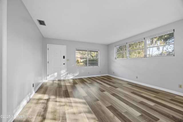 unfurnished room with wood-type flooring