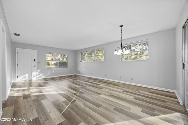 interior space featuring a chandelier and light wood-type flooring