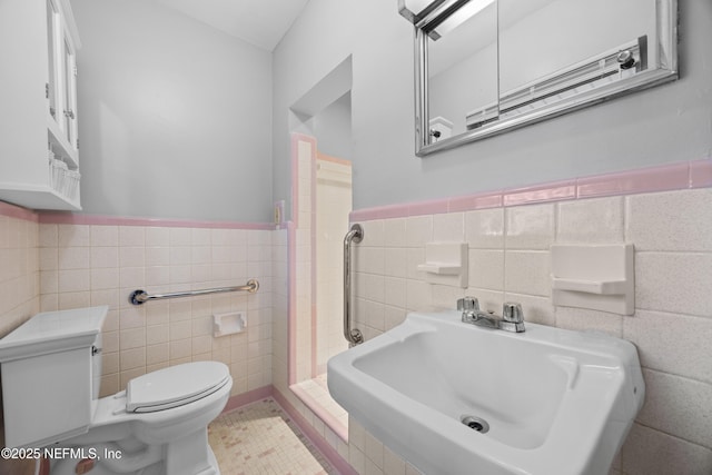 bathroom with tile walls, sink, and toilet