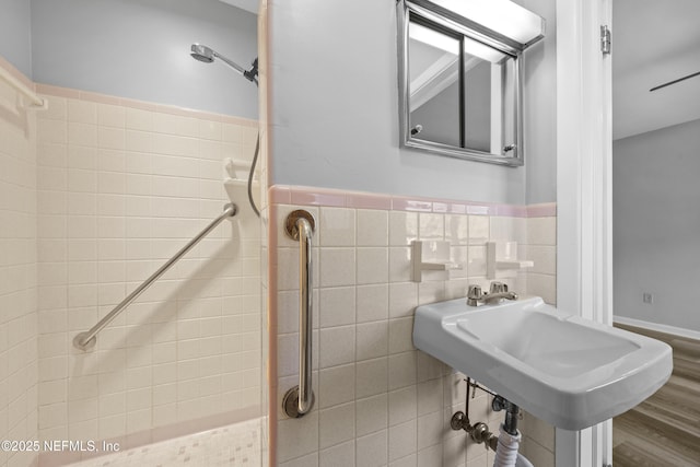 bathroom featuring hardwood / wood-style floors, sink, and tile walls