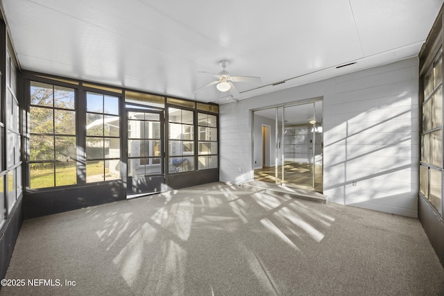 unfurnished sunroom with ceiling fan and a wealth of natural light