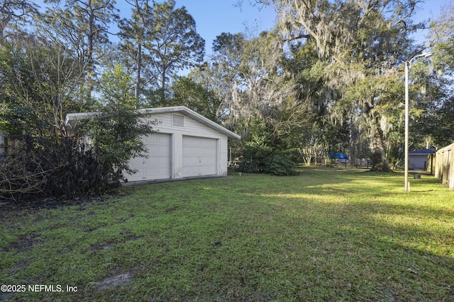 view of yard with an outbuilding and a garage