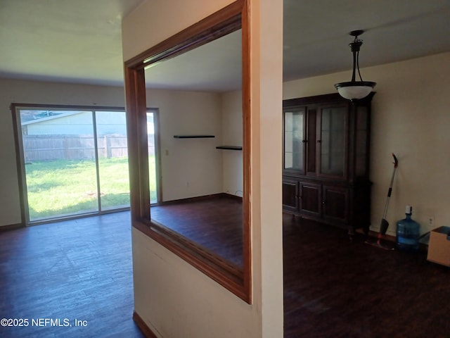 hallway with hardwood / wood-style floors