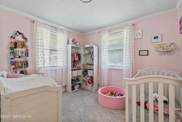 bedroom featuring light colored carpet, ornamental molding, a closet, and a textured ceiling