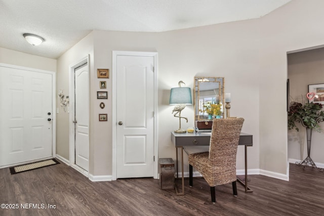 entryway with dark hardwood / wood-style flooring and a textured ceiling