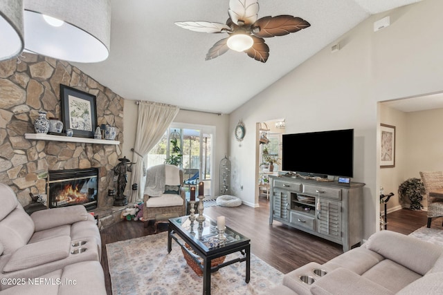 living room featuring dark wood-type flooring, ceiling fan, and a fireplace