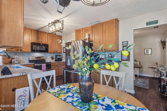 kitchen with sink, backsplash, dark wood-type flooring, and stainless steel appliances