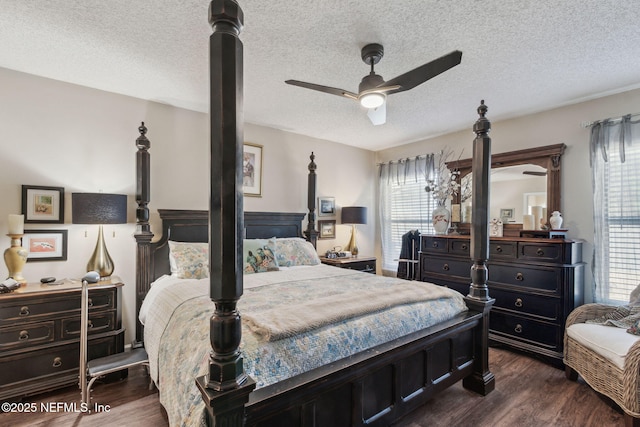 bedroom featuring dark wood-type flooring, ceiling fan, and a textured ceiling