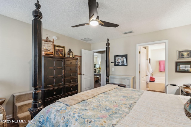 bedroom with ensuite bathroom, ceiling fan, and a textured ceiling