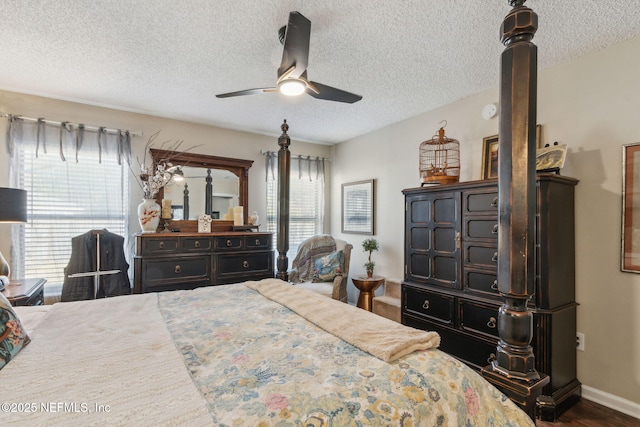 bedroom with ceiling fan, dark hardwood / wood-style floors, and a textured ceiling