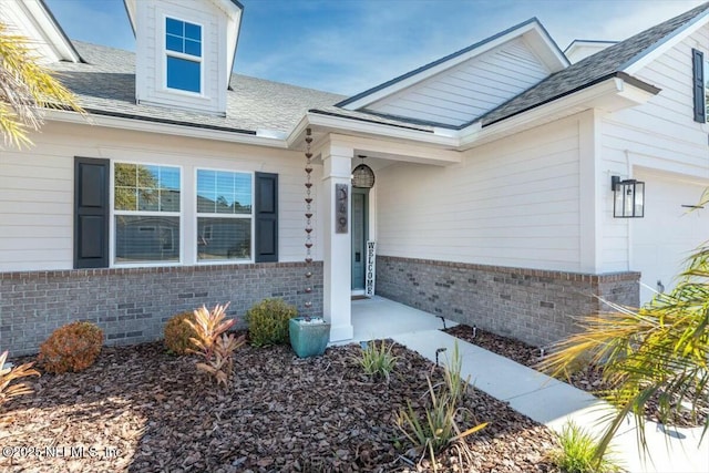 view of exterior entry with a garage