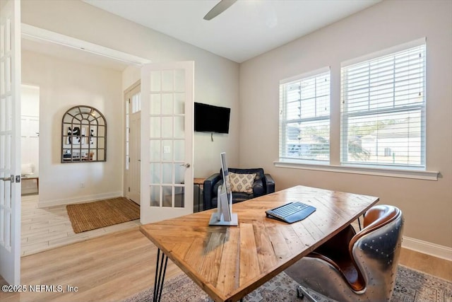 office space with french doors, ceiling fan, and light hardwood / wood-style flooring