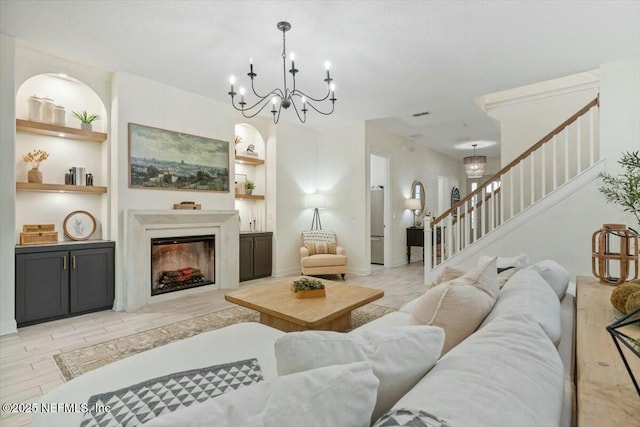 living room with light wood-type flooring and built in shelves