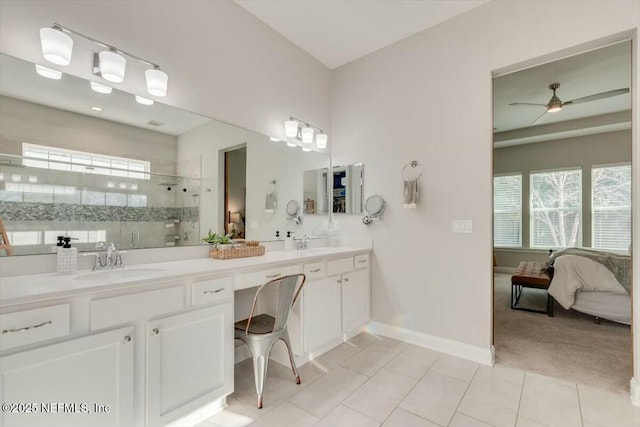 bathroom with a shower with door, vanity, tile patterned floors, and ceiling fan