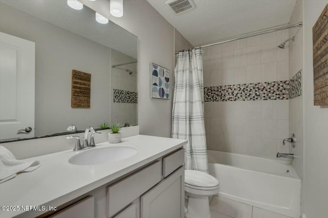 full bathroom featuring shower / tub combo with curtain, toilet, a textured ceiling, vanity, and tile patterned flooring