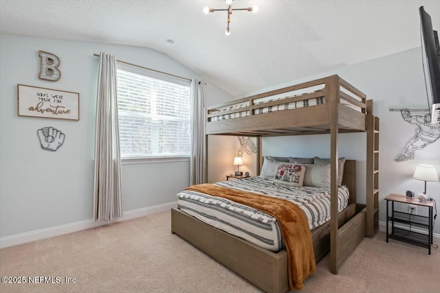 bedroom with light carpet, vaulted ceiling, and a textured ceiling