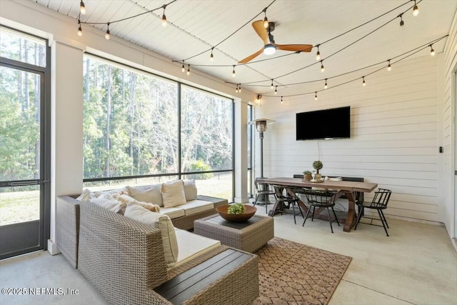 sunroom featuring ceiling fan and rail lighting