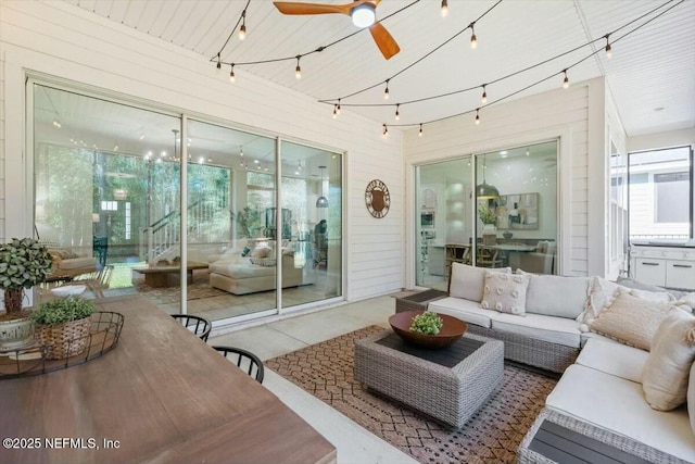 living room with ceiling fan and rail lighting