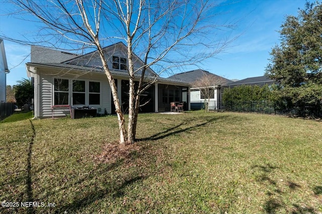 rear view of house featuring a lawn