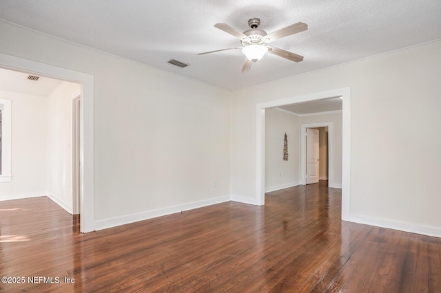 empty room featuring dark wood-type flooring, a textured ceiling, and ceiling fan