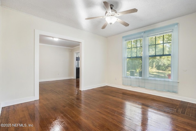 spare room featuring ceiling fan, ornamental molding, dark hardwood / wood-style floors, and a textured ceiling