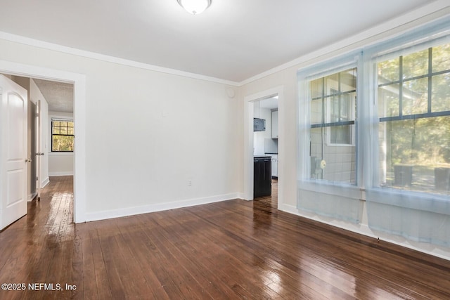 unfurnished room featuring ornamental molding and dark wood-type flooring