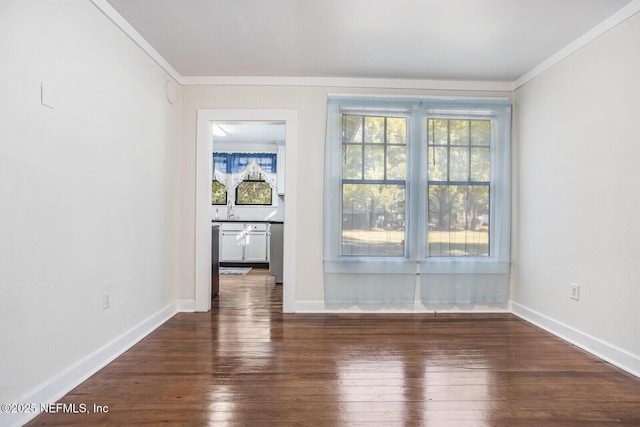 unfurnished room with sink, crown molding, and dark wood-type flooring